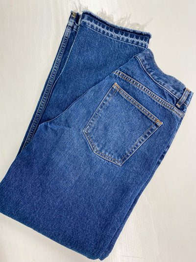 Dark wash jeans with frayed bottoms