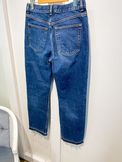 Dark wash jeans with frayed bottoms