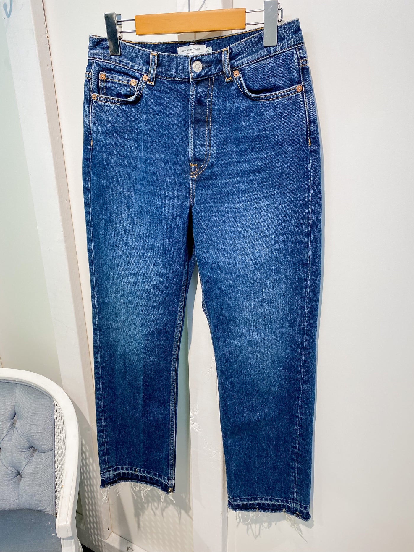Dark wash jeans with frayed bottoms